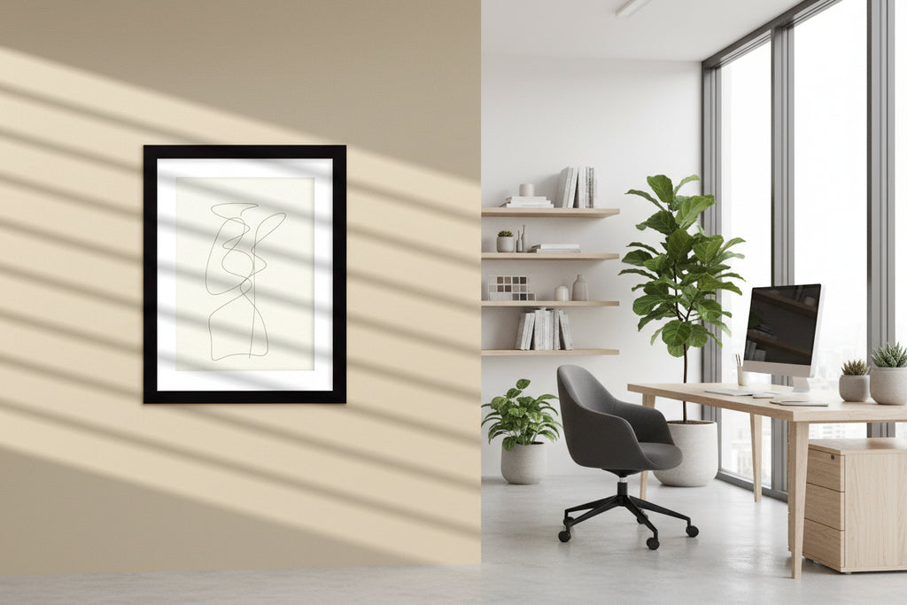 Framed abstract line art on a beige wall with shadow patterns